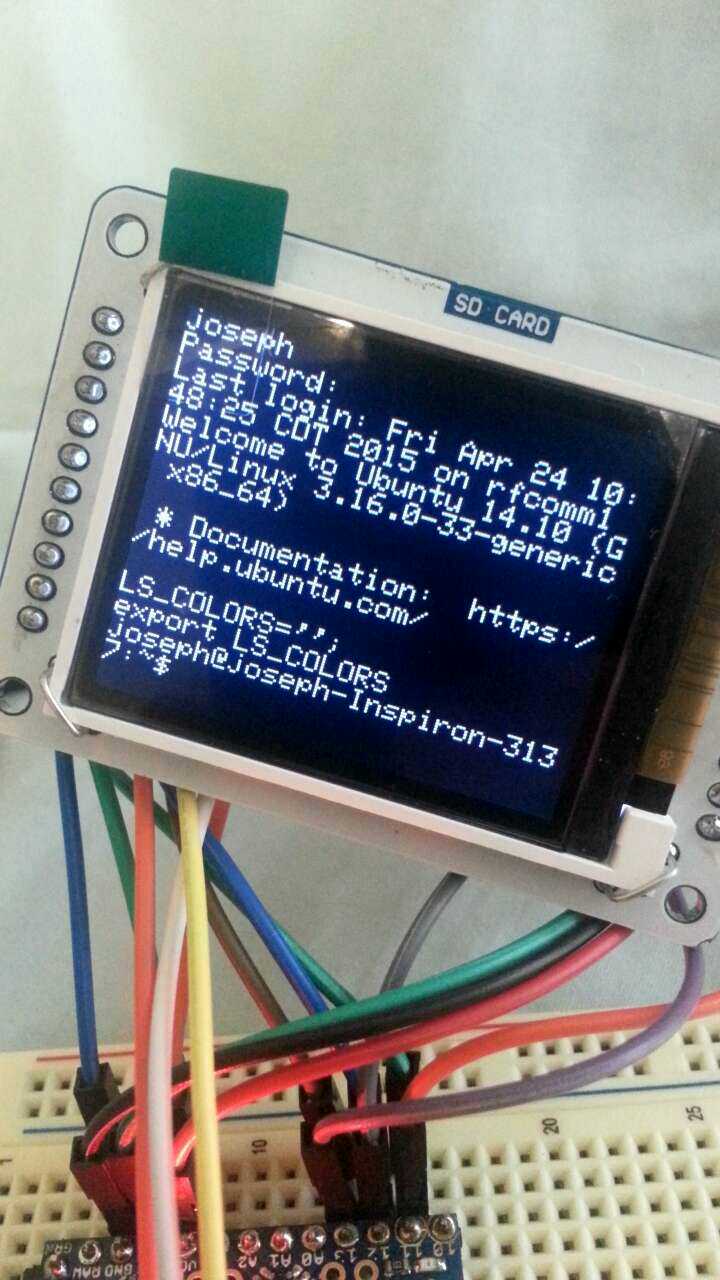 Display connected to microcontroller showing Linux serial console